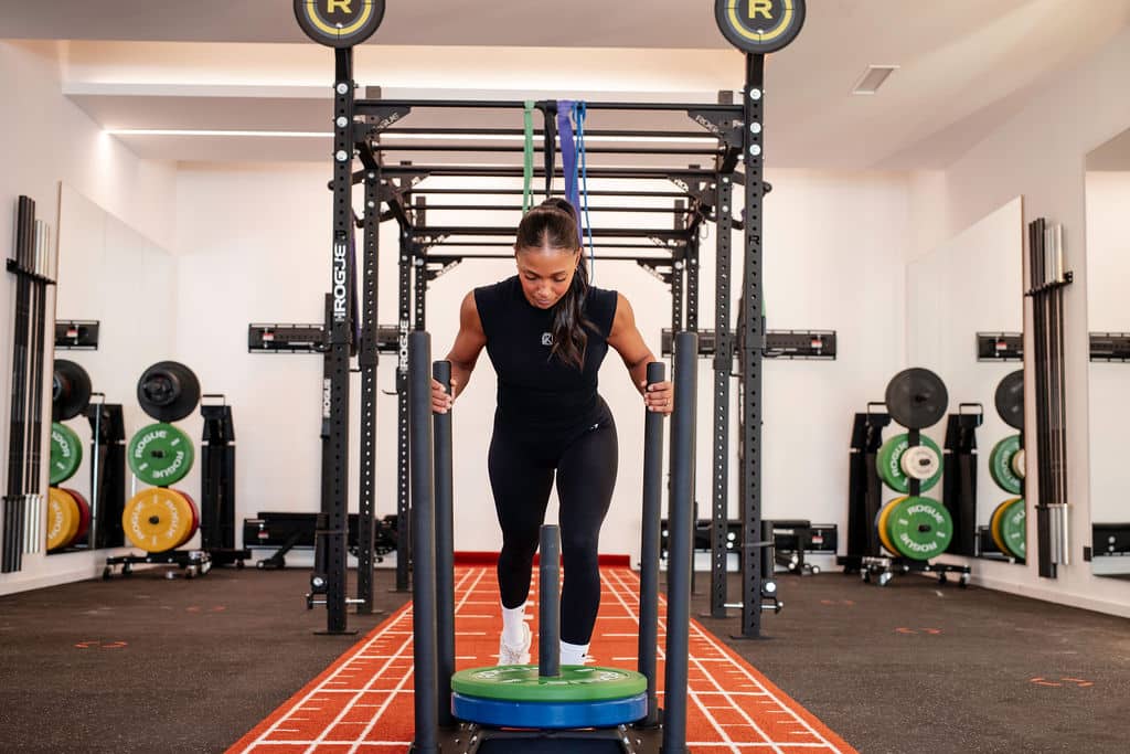 Leah doing sled push at Active Spirit